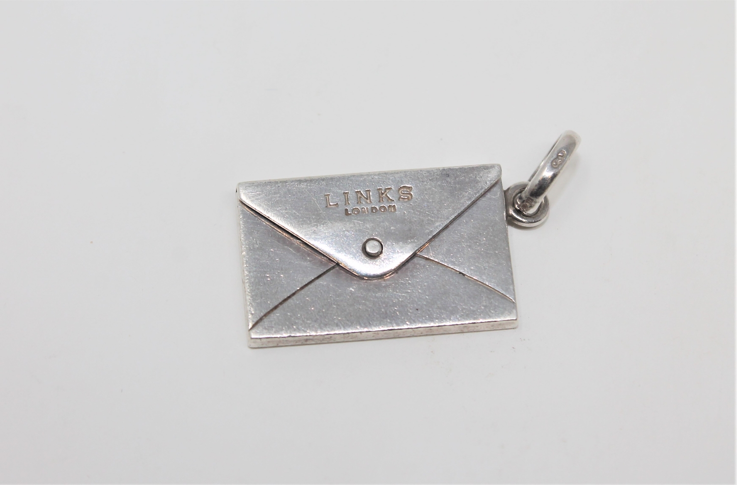 A Silver Links of London envelope locket