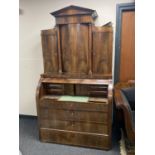 A nineteenth century mahogany barrel fronted bureau fitted with four drawers and four cupboards