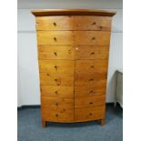 A pine Gentleman's wardrobe, with multi drawer effect front, width 114 cm.