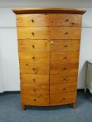 A pine Gentleman's wardrobe, with multi drawer effect front, width 114 cm.