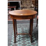 An inlaid mahogany oval work table containing sewing accessories
