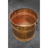 A copper swing handled log bucket