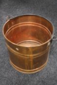 A copper swing handled log bucket