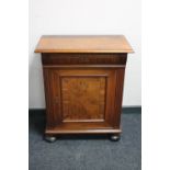 An antique walnut cupboard on bun feet CONDITION REPORT: Bun feet with considerable