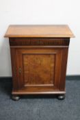 An antique walnut cupboard on bun feet CONDITION REPORT: Bun feet with considerable