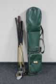 A vintage golf bags containing a set of Crest irons,