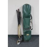 A vintage golf bags containing a set of Crest irons,