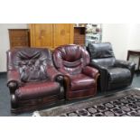 A wooden framed Burgundy leather armchair together with a leather chair and brown leather Lazy-boy