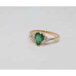 A 14ct gold emerald and diamond ring, the pear-cut emerald weighing 0.