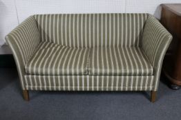 A mid 20th century continental two seater settee in striped fabric