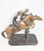 A patinated cast bronze group of jockeys on horseback,