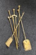 An antique brass five piece companion set