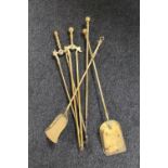 An antique brass five piece companion set