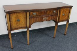 An inlaid mahogany serpentine fronted sideboard CONDITION REPORT: 166cm wide by