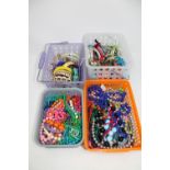Four baskets of costume bangles and bead necklaces