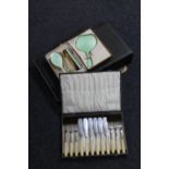 A cased three piece dressing table brush set together with a boxed plated tea service and two sets