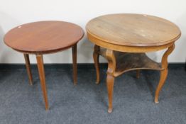 A circular continental oak occasional table with undershelf together with a further mahogany