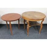 A circular continental oak occasional table with undershelf together with a further mahogany