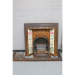 A Victorian cast iron tiled fire surround with insert and curb