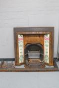 A Victorian cast iron tiled fire surround with insert and curb