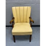 A walnut Art Deco style armchair upholstered in a cream fabric
