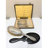 A silver backed dressing table brush,