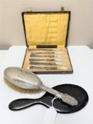 A silver backed dressing table brush,