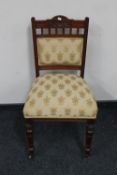 A Victorian mahogany dining chair upholstered in golden fleur de lis fabric