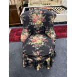 A mid twentieth century bedroom chair upholstered in a floral fabric