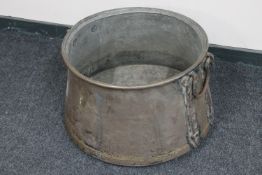 A large antique copper twin handled cooking pot