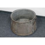 A large antique copper twin handled cooking pot