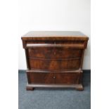 An antique mahogany four drawer chest with pillar column support