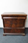 An antique mahogany four drawer chest with pillar column support