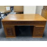 A carved Oriental twin pedestal writing desk fitted with six drawers