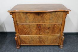 A 19th century continental mahogany three drawer chest with serpentine top