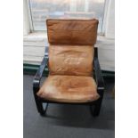 A 20th century Danish wood framed armchair with tan leather cushion