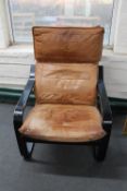 A 20th century Danish wood framed armchair with tan leather cushion