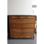 An inlaid oak seven drawer chest