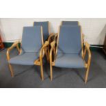 A set of four 20th century beech framed armchairs in blue fabric