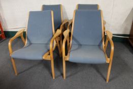 A set of four 20th century beech framed armchairs in blue fabric