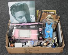 A box of Elvis Presley memorabilia to include a die cast pink Cadillac, playing cards,