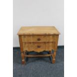 A continental blond oak serpentine fronted two drawer chest