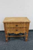 A continental blond oak serpentine fronted two drawer chest