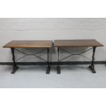 A pair of rectangular bar tables on cast iron legs