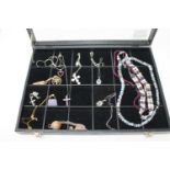 A jewellery display box containing nine various silver gem set pendants,