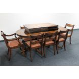 An inlaid mahogany twin pedestal dining table together with two extension leaves and eight chairs