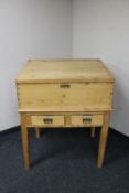 An early twentieth century pine clerk's desk on stand fitted with two drawers
