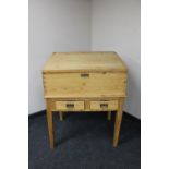 An early twentieth century pine clerk's desk on stand fitted with two drawers