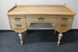 An early 20th century blond oak dressing table