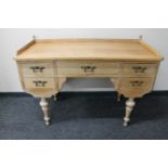 An early 20th century blond oak dressing table